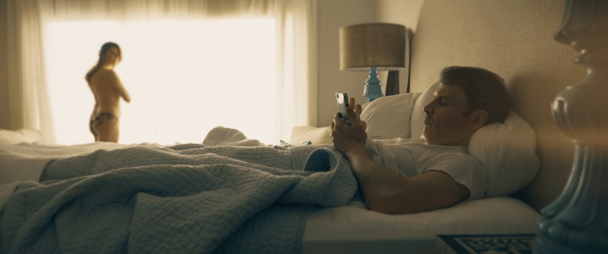 Frank on his phone, Donna in the background