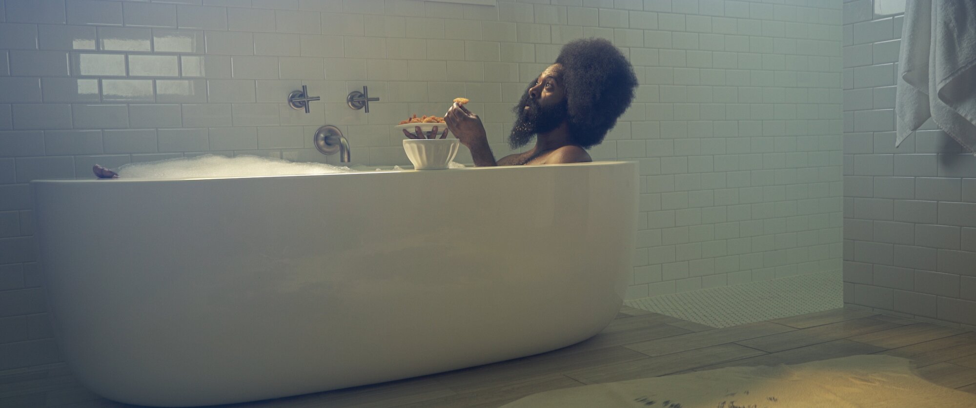 Purvis eating cereal in a bathtub