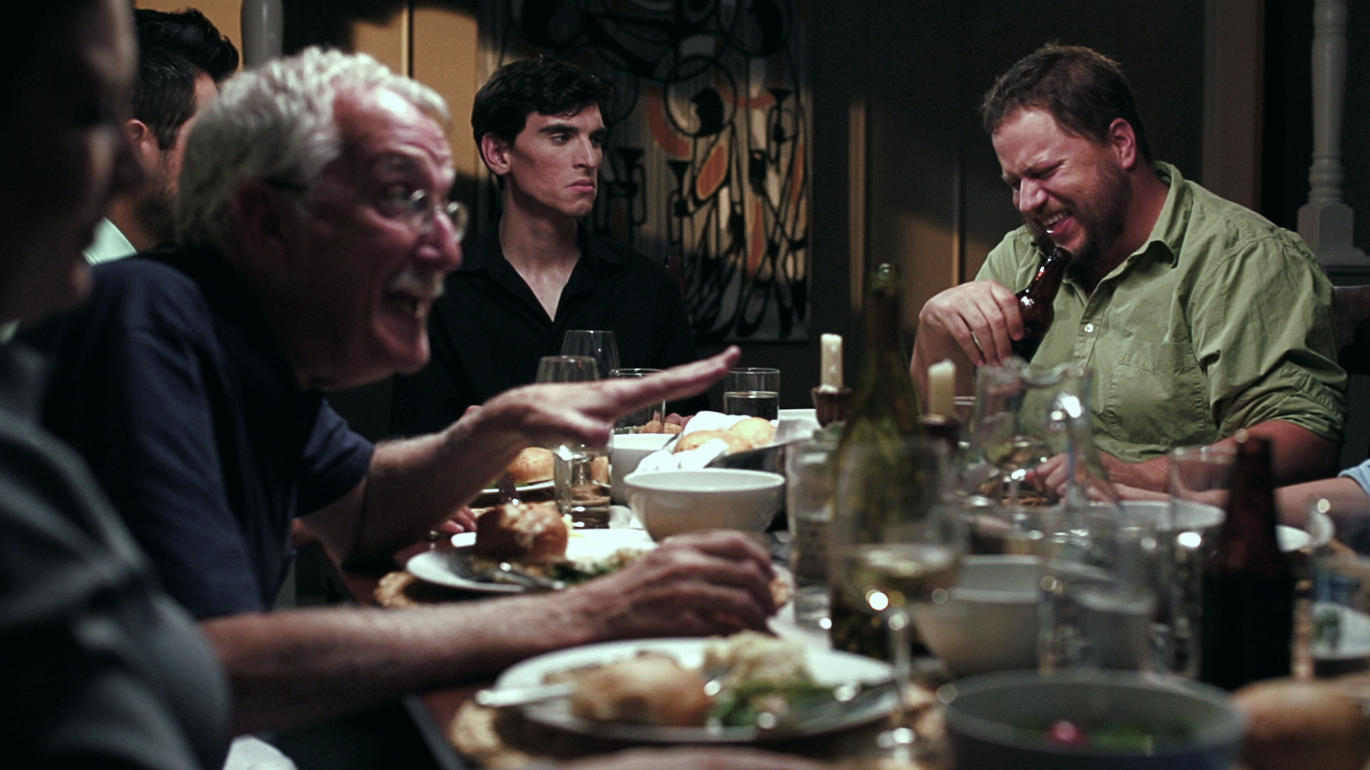 Film still — dinner table conversation